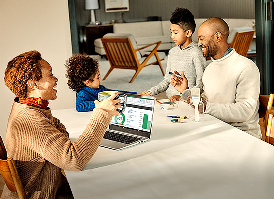 family around a laptop